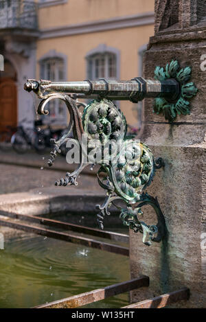 FREIBURG IM BREISGAU, GERMANY - JUNE 15, 2019: selective focus on the tap of an ornamental fountain Stock Photo