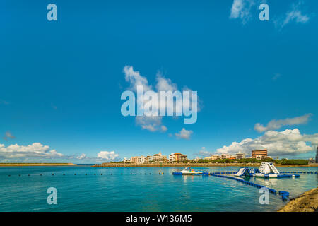 Inflatable slide for water sports, jet ski and motor boating in the Hamakawa fishing port in the vicinity of the American Village in Chatan City of Ok Stock Photo