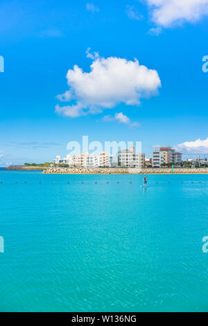 man doing paddle surfing in the Hamakawa fishing port in the vicinity of the American Village in Chatan City of Okinawa. Stock Photo