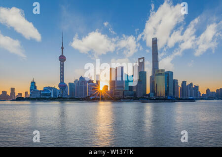 Standing on the edge of the Huangpu River, looking at the Oriental Pearl Tower and the World Trade Center on the other side, in the light of the morning light, it is so charming and spectacular. Stock Photo