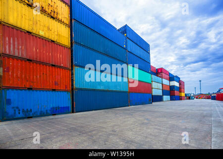 stack of containers with empty road in front Stock Photo