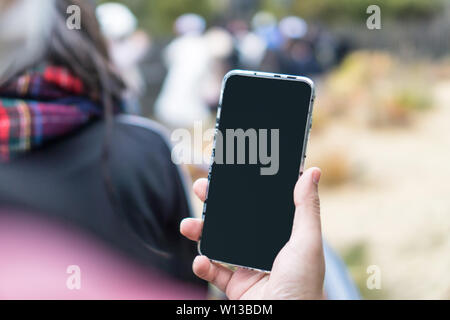 Male hand holding modern blank screen smartphone Stock Photo