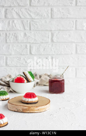 Chocolate-covered biscuits with marshmallow layer and marmalade hat Stock Photo