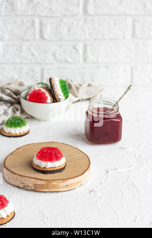 Chocolate-covered biscuits with marshmallow layer and marmalade hat Stock Photo