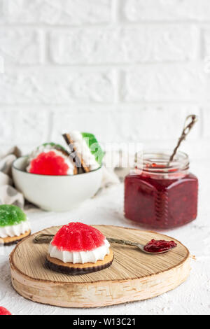 Chocolate-covered biscuits with marshmallow layer and marmalade hat Stock Photo