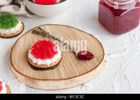 Chocolate-covered biscuits with marshmallow layer and marmalade hat Stock Photo