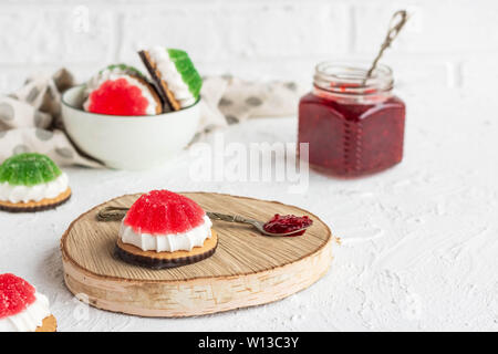 Chocolate-covered biscuits with marshmallow layer and marmalade hat Stock Photo