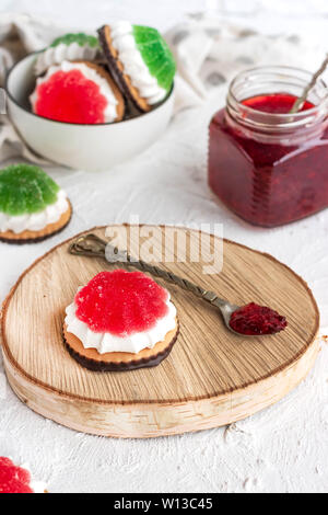 Chocolate-covered biscuits with marshmallow layer and marmalade hat Stock Photo