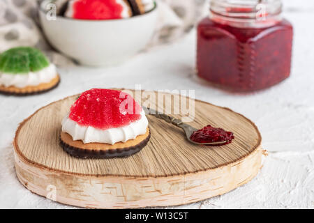 Chocolate-covered biscuits with marshmallow layer and marmalade hat Stock Photo