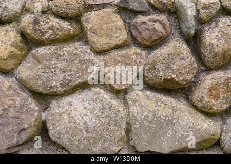 Close up a wall of big round stones Stock Photo