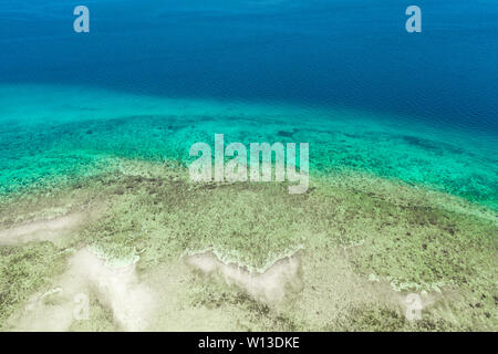 Transparent sea water, top view. Aerial view of calm sea water. Top view of a clean ocean water near a coast. Stock Photo