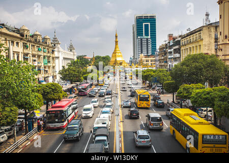 View on the Yangon city downtown with traffic and golden stupa of Sule Pagoda. Sula Pagoda is Landmark od Yangon and Burma. Stock Photo