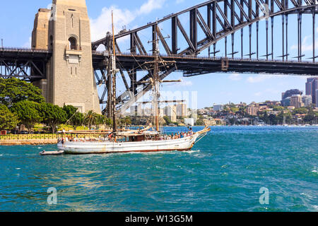 Sydney, Australia - October 4th 2014: A tour boat heads out under the Harbor Bridge. Boat trips are popular with tourists. Stock Photo