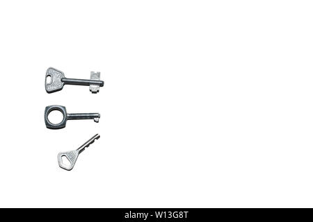 Three old different keys isolated on the white background with copy space. Stock Photo