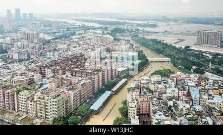 (190630) -- GUANGZHOU, June 30, 2019 (Xinhua) -- Photo taken on June 5, 2019 shows the general view of Chebei Village with rowers paddling the dragon boats in Chebei, Guangzhou, south China's Guangdong province. Chebei is an ancient village with a history of more than 1,000 years and over 200,000 permanent residents in Guangzhou, south China's Guangdong province. The Chebei Village Dragon Boat is listed as the intangible cultural heritage of Guangzhou. The Dragon Boat Festival consists of many key steps which has been preserved integrally.    On the eighth day of the fourth lunar month, the da Stock Photo