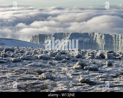 glacier remains and snow covered summit of Mount Kilimanjaro in Tanzania just after sunrise Stock Photo