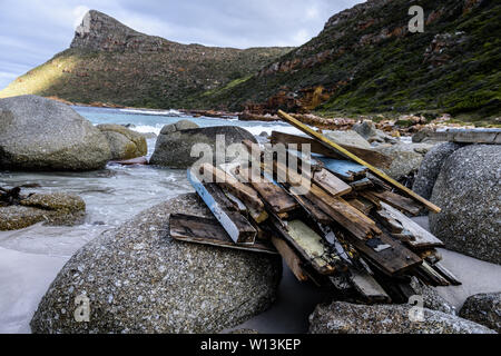 Driftwood is stacked on the rocks to dry at South Africa's Smitswinkel Bay on the Cape Peninsula's False Bay coastline, near the city of Cape Town Stock Photo