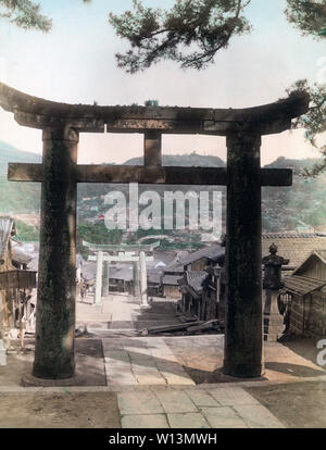 [ 1890s Japan - Suwa Jinja Shrine, Nagasaki ] —   A view of Nagasaki, seen through the torii (sacred gate) of Suwa Jinja, Nagasaki’s most prominent shinto shrine first constructed in 1624. Three torii can be seen.  19th century vintage albumen photograph. Stock Photo