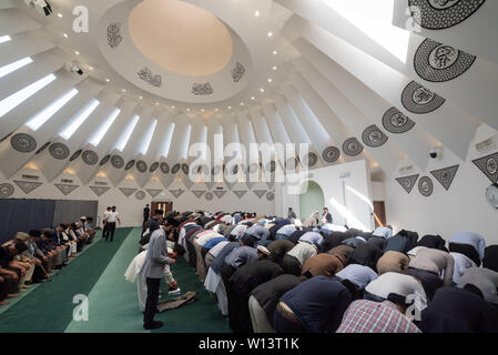Mubarak Mosque, Sheephatch Lane, Tilford, Surrey, UK. 29th June 2019. Pictured:  Muslims pray inside the Mubarak Mosque. / Hundreds of muslims together with Members of Parliament, Secretaries of State and leaders of various faiths attend the inauguration of the Mubarak Mosque in the Surrey countryside, the new home for the international headquarters of the Ahmadiyya Muslim Community. After a period of 35 years, the Headquarters of the Ahmadiyya Muslim Community moved from the Fazl Mosque in Southfields, London, to Islamabad in Tilford, Surrey. Credit: Lee Thomas/Alamy Live News Stock Photo