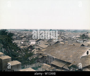 [ 1890s Japan - City of Utsunomiya, Japan ] —   General view of Utsunomiya, Tochigi Prefecture. Carpenters can be seen working on the large building in front.  19th century vintage albumen photograph. Stock Photo