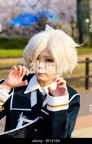 Costume play event at Kumamoto castle Park, Japan. Portrait of cos player young woman with white hair posing for viewer and fingers curled to scratch. Stock Photo