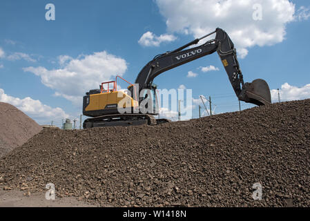 heavy wheel loader excavator on a rocky hill Stock Photo