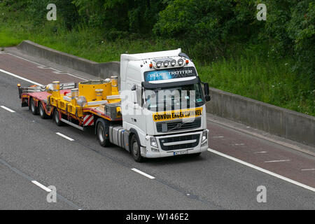 Convoi Exceptional Volvo truck; Motorway heavy loads, bulk Haulage delivery trucks, lorry, transportation, wide load escorted truck, special cargo, vehicle, delivery, transport, industry, oversize freight on the M6 at Lancaster, UK Stock Photo