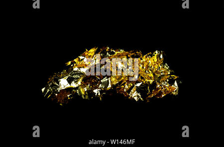 Scraps gold foil and empty space on black background Stock Photo