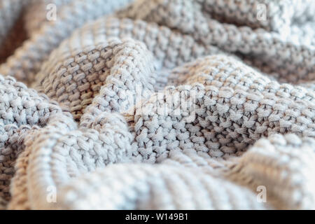 Abstract of a soft knit grey throw blanket with selective focus in center Stock Photo