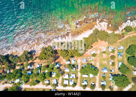 Camping by the sea and crystal clear stone beach aerial view in Savudrija, Istria region of Croatia Stock Photo