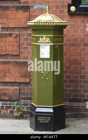 A green painted Victorian Penfold pillar box with a VR monogram, for Victoria Regina, Queen Victoria. Pillar boxes were painted green until 1874 when Stock Photo