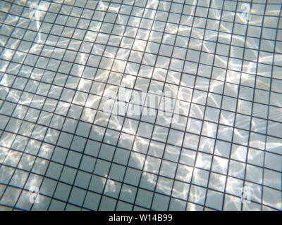 underwater view of swimming pool floor with sunlight reflections. concept of leisure activities Stock Photo