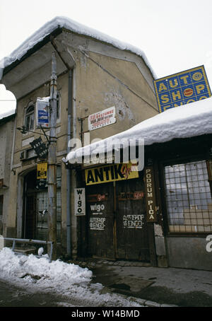 28th March 1993 During the Siege of Sarajevo: a shut-down antiques store at 93 Marsala Tita Street in the Baščaršija area. On a gable wall above it is the typical scar of a direct hit from a mortar or artillery shell. Stock Photo