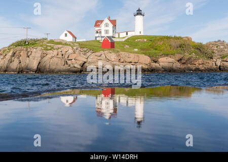 Reflection of Historic Nubble Lighthouse on Cape Neddick in York, Maine Stock Photo