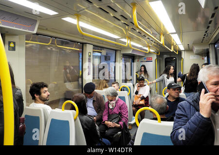 Passengers sitting in underground subway carriage talking and speaking on mobile phone on metro train in Porto Oporto Portugal Europe EU KATHY DEWITT Stock Photo