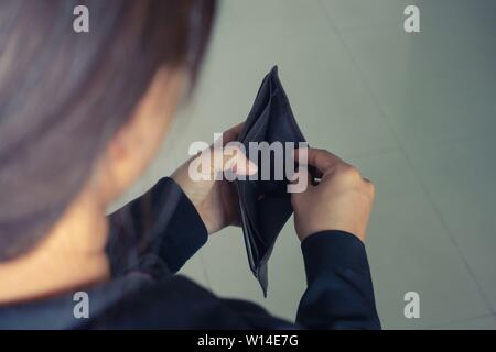 woman open wallet with no money inside Stock Photo