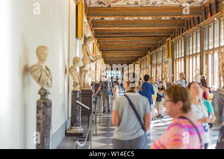 Florence, Italy - September 25, 2016: Tourists in hallway of Uffizi Gallery, one of the oldest and most famous art museums of Europe. Stock Photo