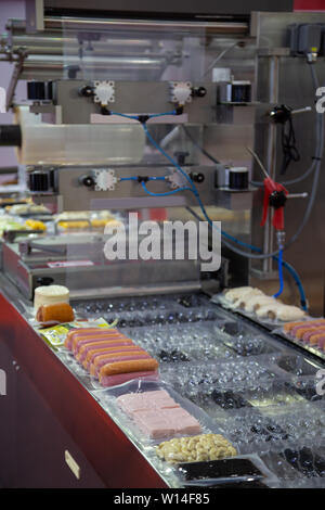 Linear tray food heat sealing and packaging machine Stock Photo