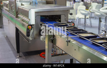 Linear tray food heat sealing and packaging machine Stock Photo