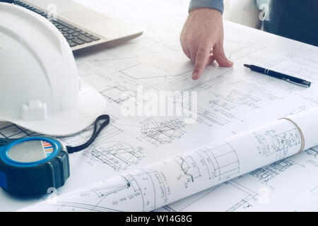 construction blueprints engineering man hard white helmet work table Stock Photo