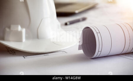 construction blueprints engineering man hard white helmet work table Stock Photo