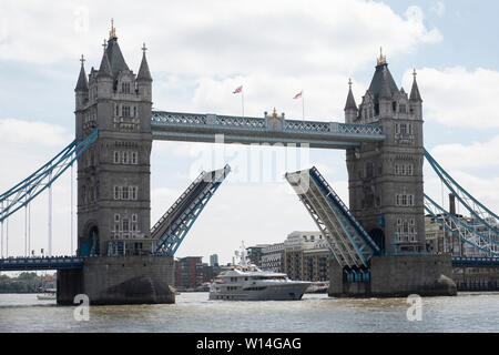 London, UK. 30th June, 2019. A ship sails beneath Tower Bridge in London, UK, June 30, 2019. London's iconic Tower Bridge celebrates its 125th anniversary on Sunday with exhibitions and special offers. Officially opened on June 30, 1894, the bridge has become the defining landmark of the British capital. It welcomed a record-breaking 864,652 visitors in 2018. Credit: Ray Tang/Xinhua/Alamy Live News Stock Photo