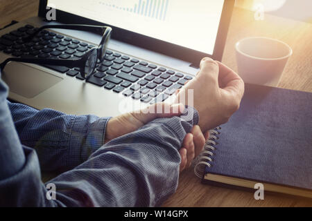 Closeup of man hand holding her wrist pain from using computer Stock Photo