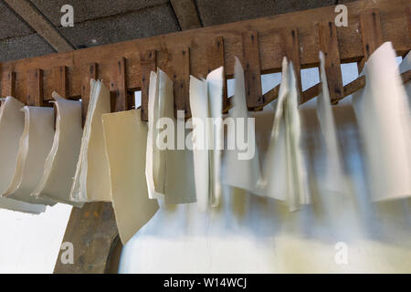 hand made paper is hanging in an old paper mill for drying Stock Photo