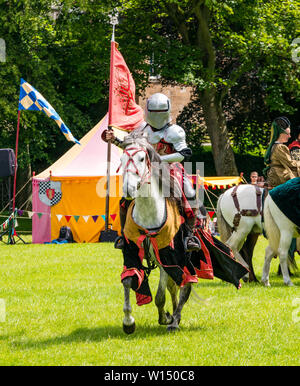 Linlithgow Palace, West Lothian, Scotland, United Kingdom, 30 June 2019. Jousting at Linlithgow Palace: Historic Environment Scotland present their annual Medieval family fun day at The Peel. The main event is a spectacular jousting and horseback riding display by the equine stunt team Les Amis D’Onno dressed as knights in Medieval costumes Stock Photo