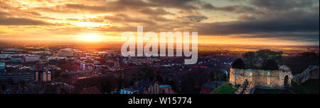 A wide panaromic shot of an epic sunset over Lincoln from the castle walls during the end of the year Stock Photo