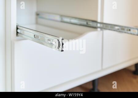 Furniture details close-up, installation of drawers in the cabinet, nobody Stock Photo