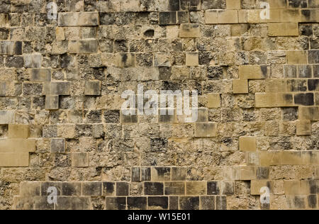 Old and weathered beige limestone brick wall Stock Photo