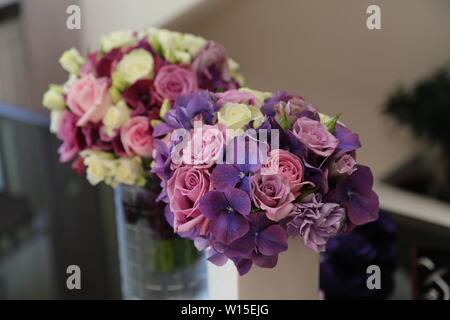 The brides bouquet is in a vase of water. Stock Photo