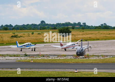 Mainz, Germany - June 20, 2019: Two microlight aircrafts and an ultralight helicopter on a small airfield in Mainz, Germany. Stock Photo